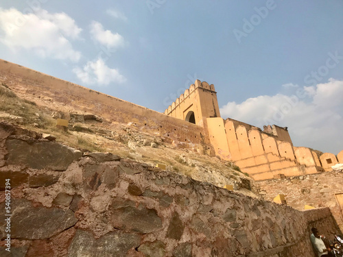 Jaipur, India, November 2019 - A stone building that has a rocky cliff