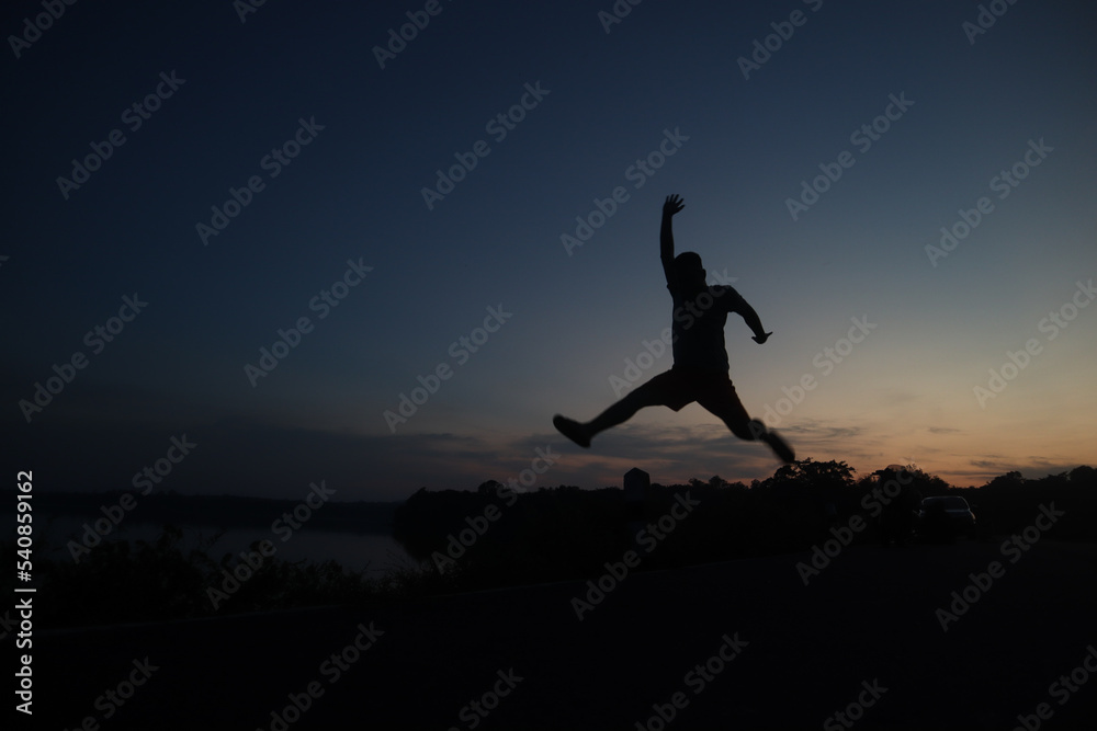 silhouette of a man jumping