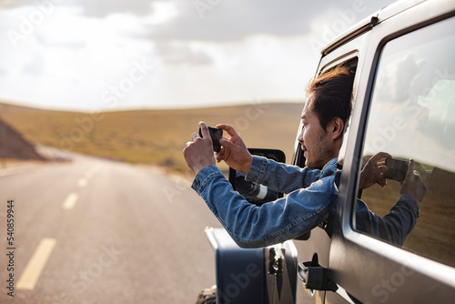 Happy mid adult man enjoying road trip