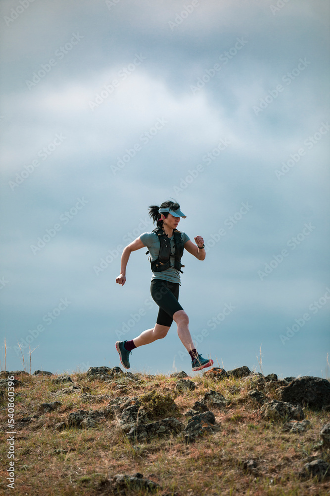 Female trail runner training in nature