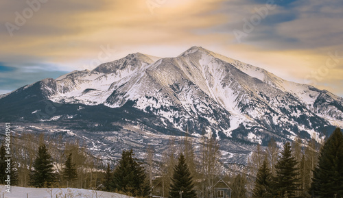 View of beautiful mountain in Rocky Mountains, Colorado, at sunset; pine trees at the bottom photo