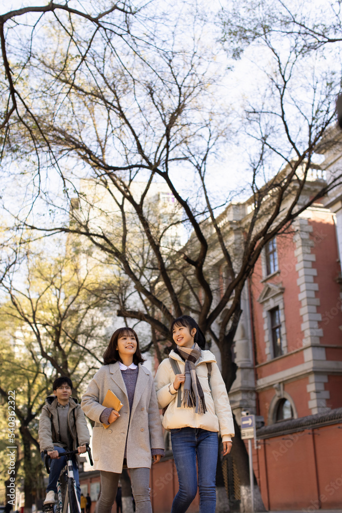 Happy college students walking on campus Happy college students walking on campus
