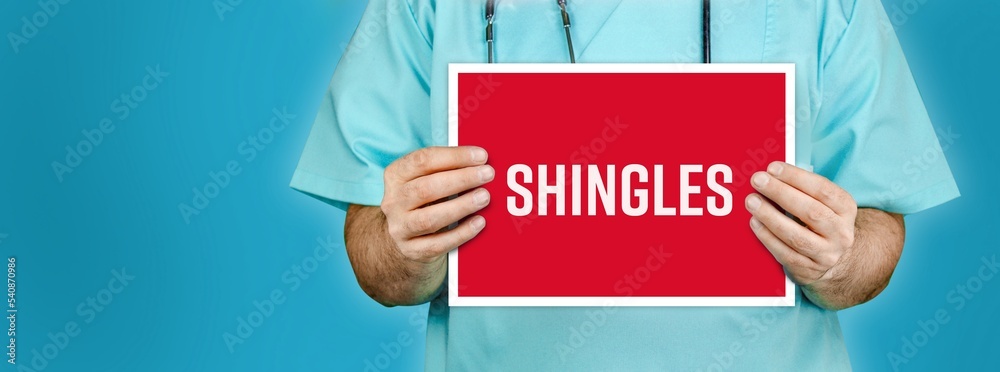 Shingles (herpes zoster). Doctor shows red sign with medical word on it. Blue background. Shingles (herpes zoster). Doctor shows red sign with medical word on it. Blue background.