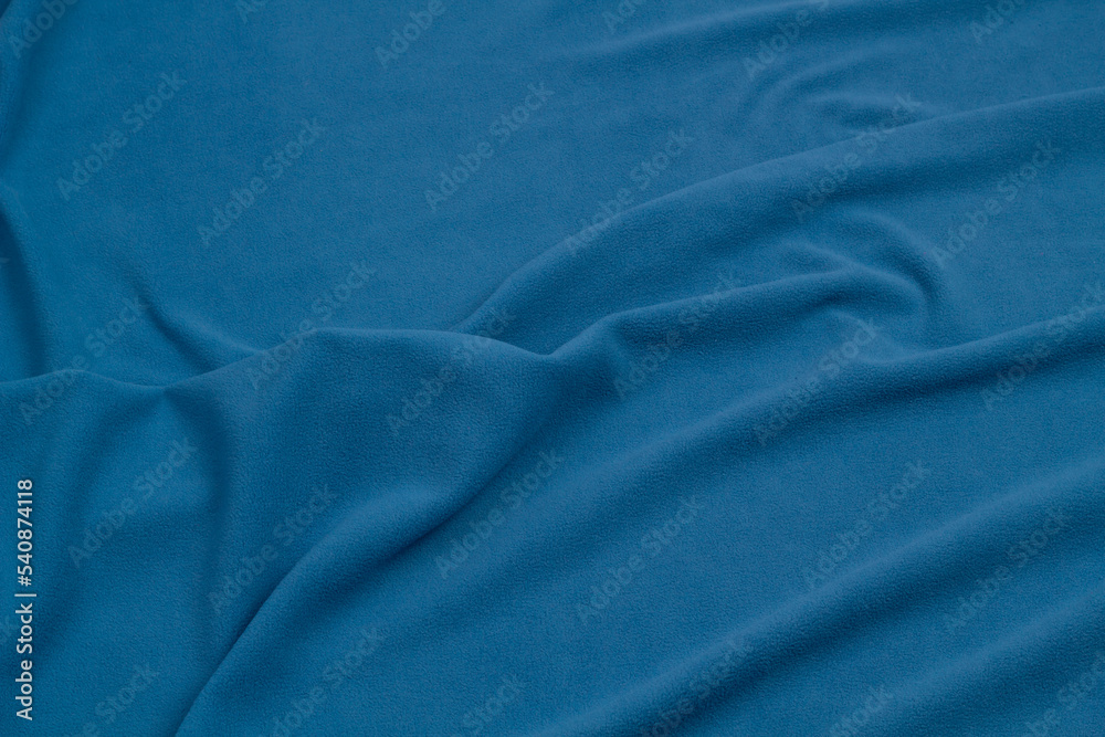 Fleece fabric blue top view. Texture of textile fleece bedspread. Fleece fabric blue top view. Texture of textile fleece bedspread.