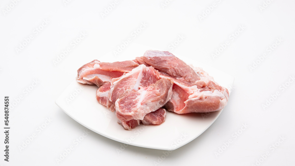 Raw soft pork ribs isolated on plate .White background. Raw soft pork ribs isolated on plate .White background.