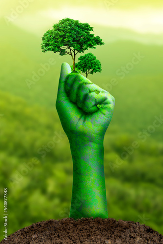 Clenched fist hand, raised fist - symbol of victory, Stranglehold by nature and trees, Environment earth day,Concept Save the world, save environment, Forest conservation concept, Protecting nature. photo