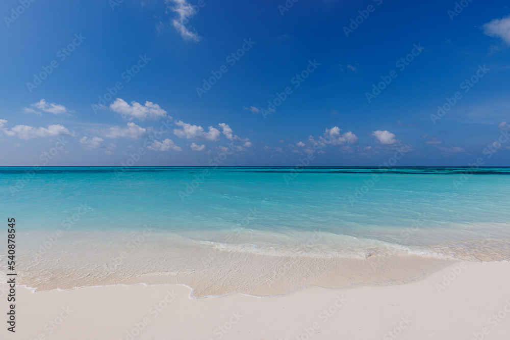 Closeup of sand on beach and blue summer sky. Panoramic beach landscape. Empty tropical beach and seascape. Peaceful shore, waves surf calmness, tranquil relaxing sunlight, summer mood