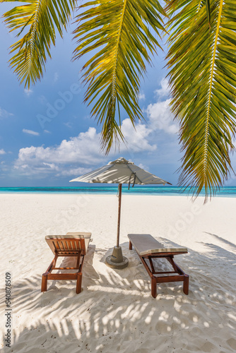 Beautiful panoramic nature. Tropical beach sunny as summer island landscape with chairs umbrella palm leaves calm sea shore  coast. Luxury travel panoramic destination banner for vacation or holiday