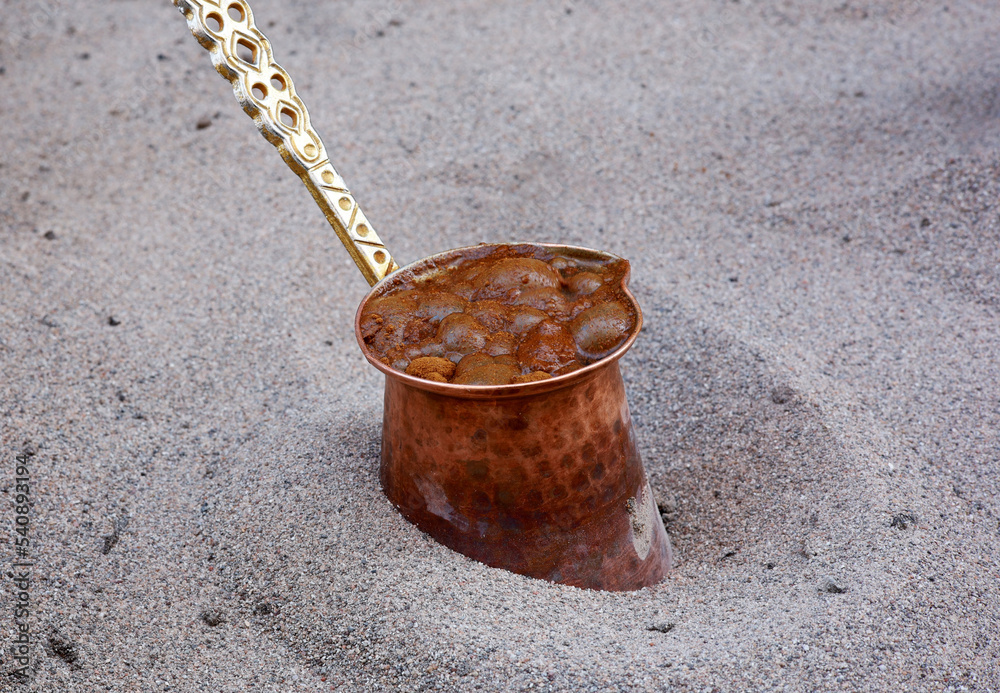 Naklejka premium Turkish coffee cooked in an antique copper pot