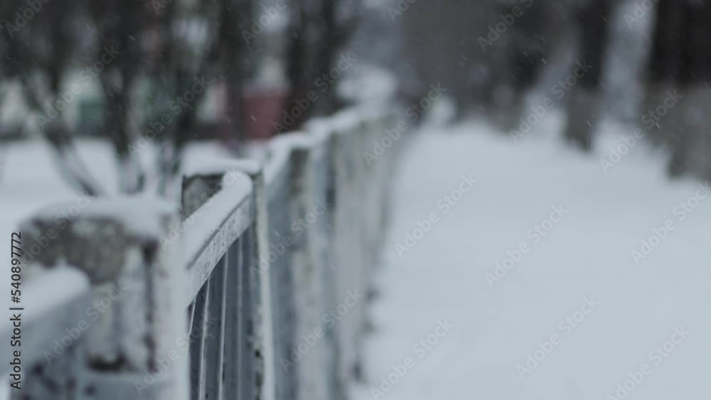 Protective fence with a metal mesh netting against the background of snow in winter, windstorm. Copy space for text