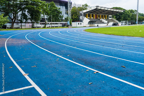 Blue track for running competition at stadium  focus on center.