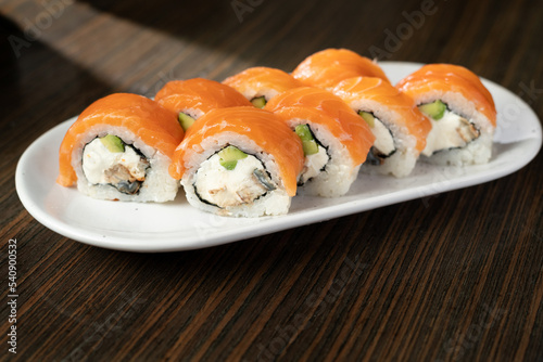 Philadelphia roll sushi with salmon, smoked eel, avocado, cream cheese. Sushi menu. Japanese food.