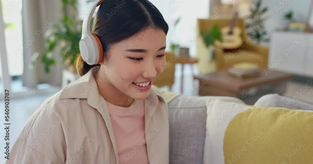 Happy, smile and woman on laptop, headphones and listening to music, social media and movie subscription in home. Content asian female typing, watching and streaming series on weekend while relax Happy, smile and woman on laptop, headphones and listening to music, social media and movie subscription in home. Content asian female typing, watching and streaming series on weekend while relax