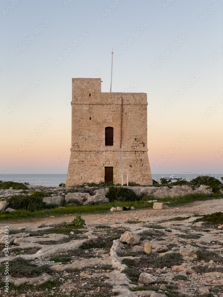Naxxar, Malta - October 24th 2022: Saint Mark's Tower on the shore of the Mediterranean Sea was completed in 1658 and is the third of the De Redin towers to be built by the Order of Saint John. Naxxar, Malta - October 24th 2022: Saint Mark's Tower on the shore of the Mediterranean Sea was completed in 1658 and is the third of the De Redin towers to be built by the Order of Saint John.