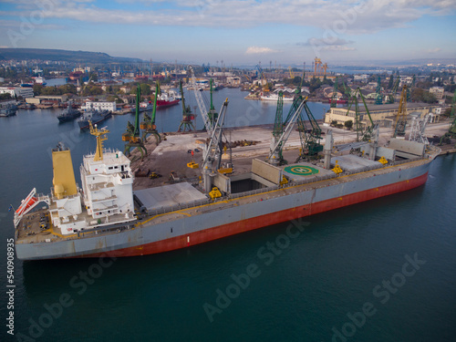Aerial view of big cargo ship bulk carrier is loaded with coal in port