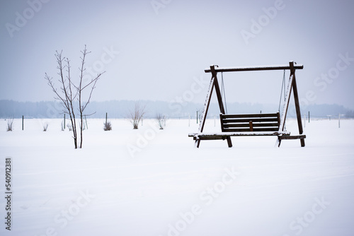 Lonely swing set in the middle of a field