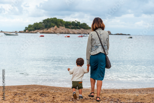 A mother with her son on the beach in the port of San Miquel on the island of Ibiza. Balearic Islands photo