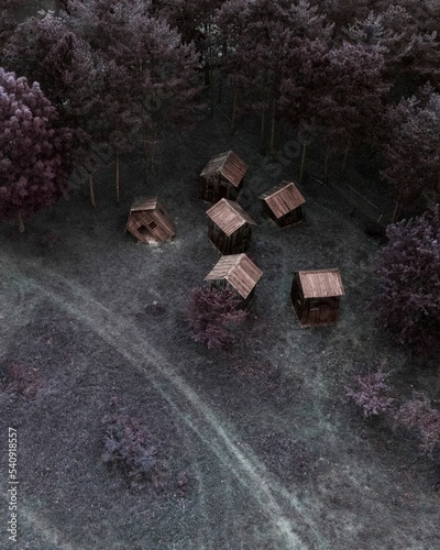 Village sculpture with wooden huts in a forest