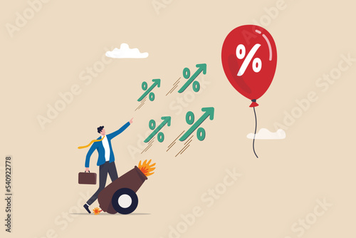 Inflation reduction act by FED, Federal Reserve and central bank to raise interest rate, monetary policy to control inflation, businessman banker shooting interest rate cannon at inflation balloon. photo