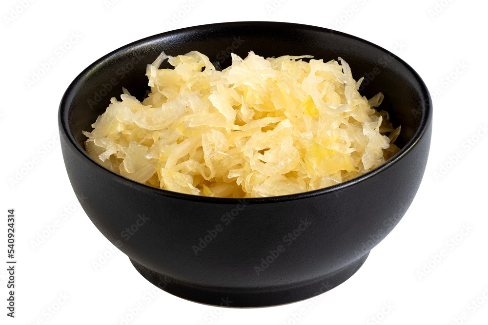 Fermented white cabbage in a black ceramic bowl isolated. Fermented white cabbage in a black ceramic bowl isolated.