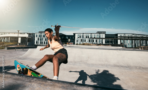 Fotografie Fitness, girl and skateboarder skateboarding in a skate park for training, cardio workout and sports exercise