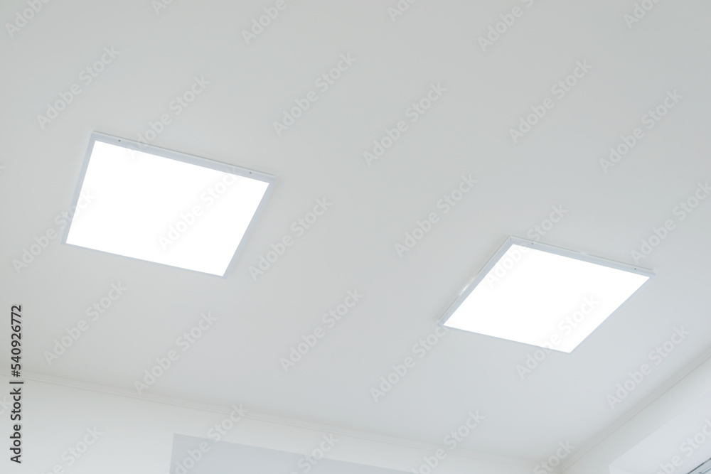 Two panels of LED light on white ceiling. LED light in office Two panels of LED light on white ceiling. LED light in office