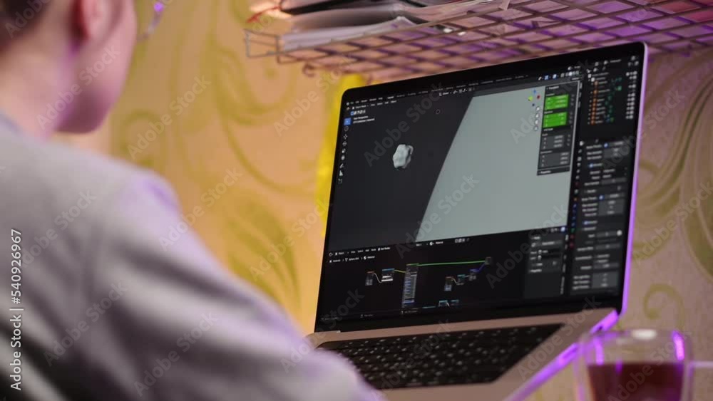 Female art director looking at 3d model while working on laptop at home. The artist girl makes a visualization using a special program. Graphic designer concept