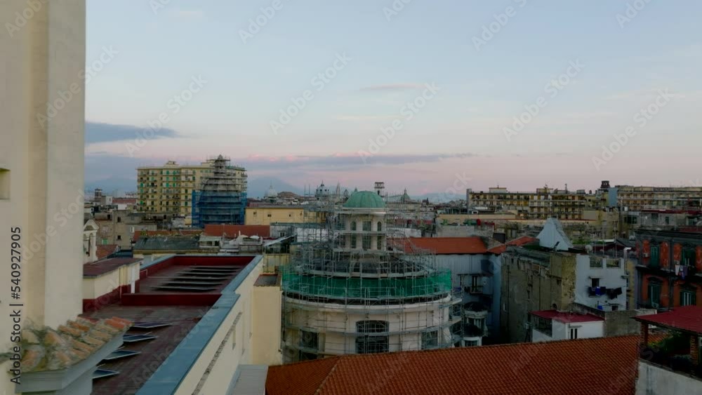 View of city through windows from dark interior. Sliding reveal of buildings in urban borough. Repairing and restoration of historic landmarks. Naples, Italy View of city through windows from dark interior. Sliding reveal of buildings in urban borough. Repairing and restoration of historic landmarks. Naples, Italy
