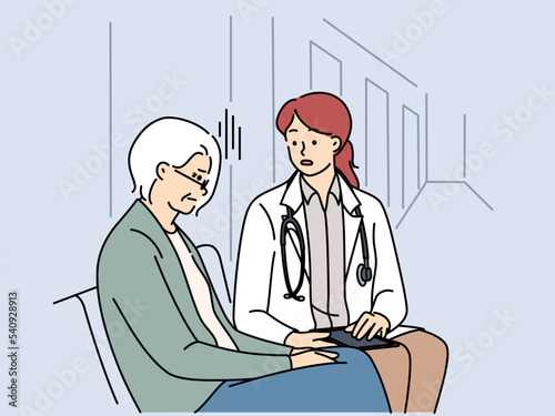 Female doctor talk with mature patient in clinic 