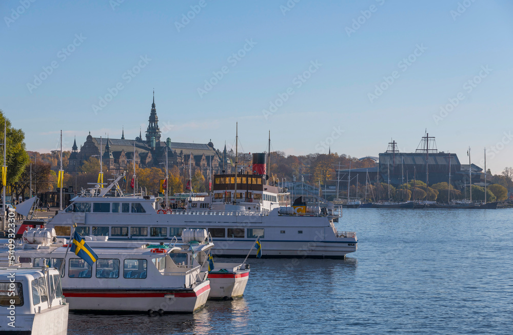 The down town bay Nybroviken with archipelago commuting boats a colorful autumn day in Stockholm