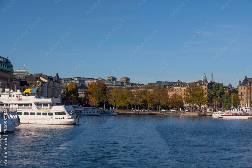 The down town bay Nybroviken with archipelago commuting boats a colorful autumn day in Stockholm