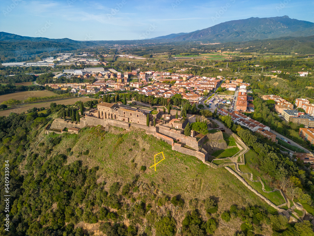 Fototapeta premium Aerial drone footage of Hostalric European medieval town in the mountains castle Church Cathedral trekking tourism a few minutes from Blanes and the Costa Brava