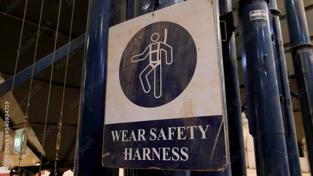 Stockvideon Caution health and safety sign with wear safety harness and