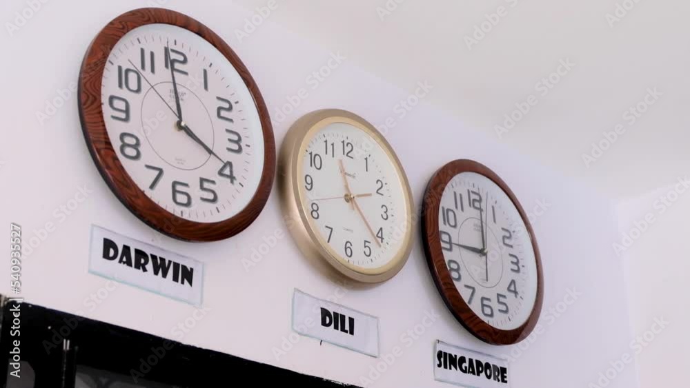 World clocks on wall with time zones from Dili Timor Leste, Darwin