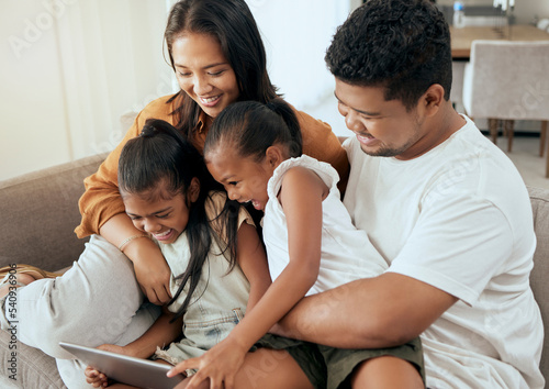 Tablet, relax and Asian family with children on sofa, watching a movie online together. Mom, dad and girls bond and playing at home using digital notebook for educational games, internet and videos