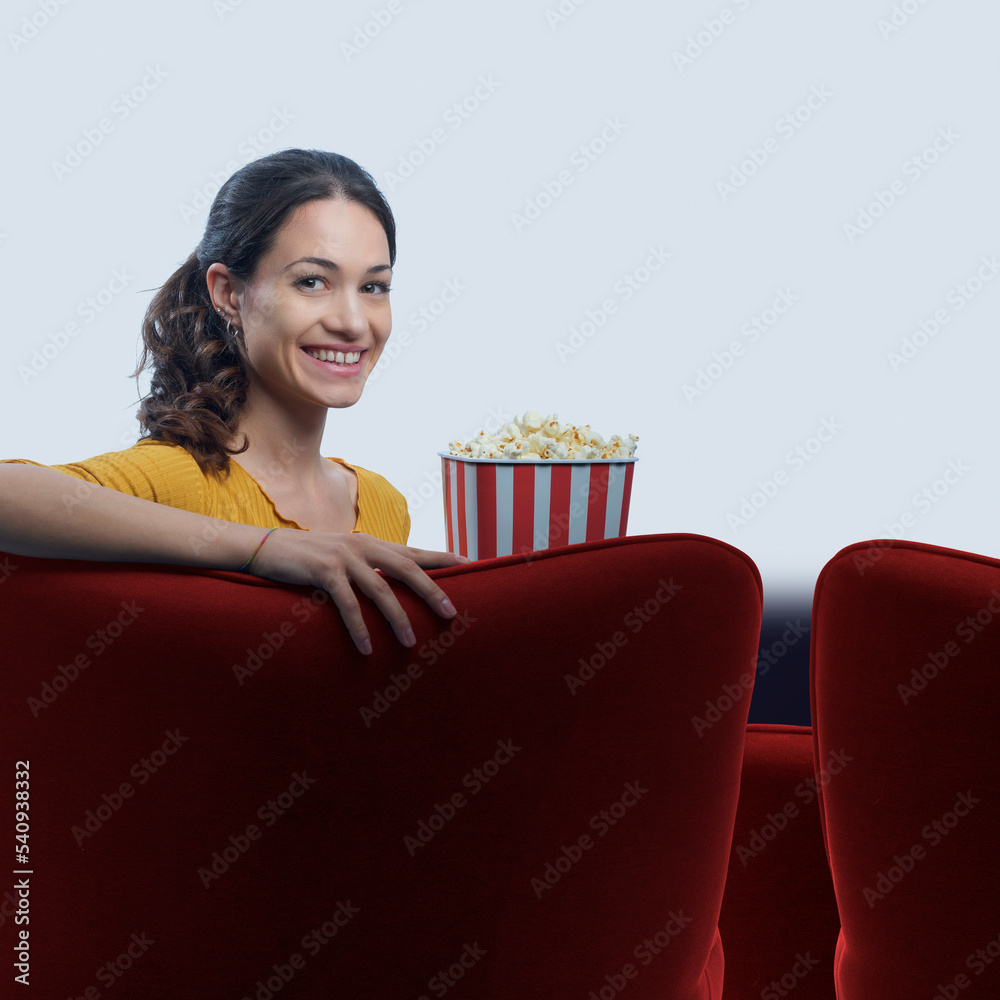 Woman eating popcorn and watching movies Woman eating popcorn and watching movies