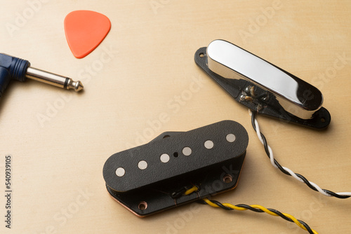 Single coil model guitar pickup set on wooden table