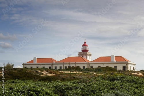 View of Cabo Sardao Lighthouse against the background of the cloudy sky. Odemira, Portugal. photo