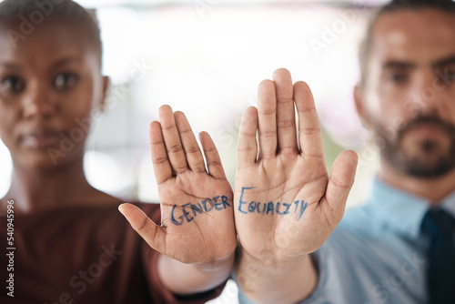 Photos Hands, gender equality and unity with a sign message on the hand of a business man and woman in the office