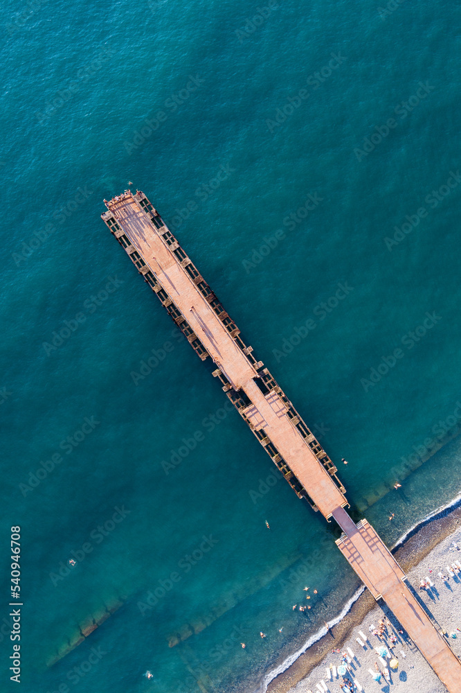 Top view of the pier going into the turquoise sea