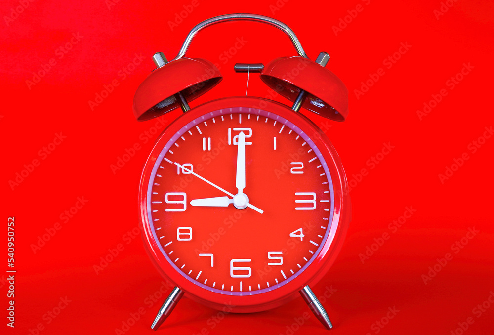 Red alarm clock on red background,with copy space Red alarm clock on red background,with copy space