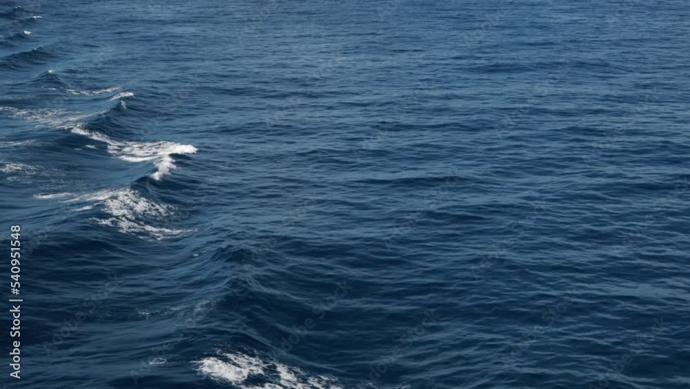 High waves. White foam on wind. Side view low on water. Wind breaks waves. Splashes High waves. White foam on wind. Side view low on water. Wind breaks waves. Splashes