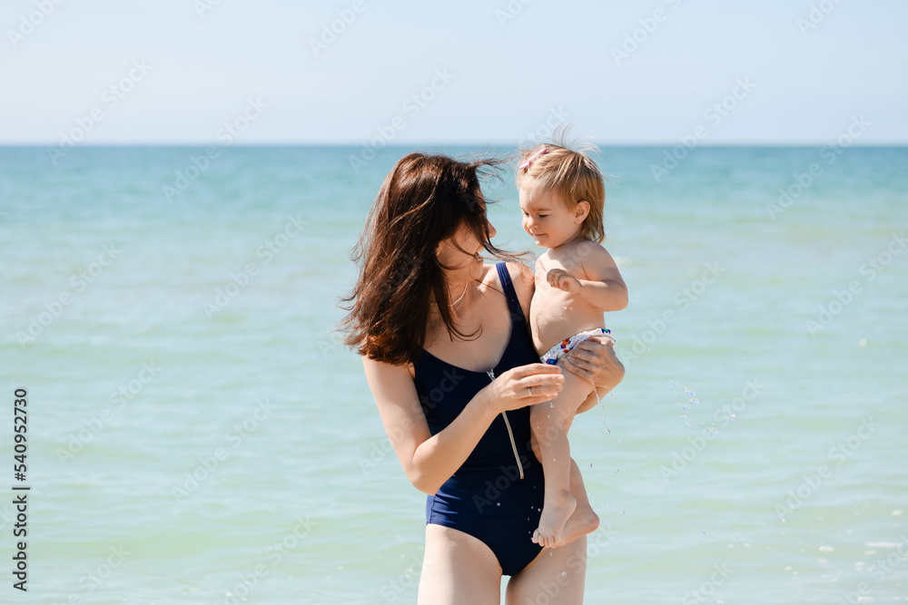 Mother with toddler girl at sea beach Mother with toddler girl at sea beach