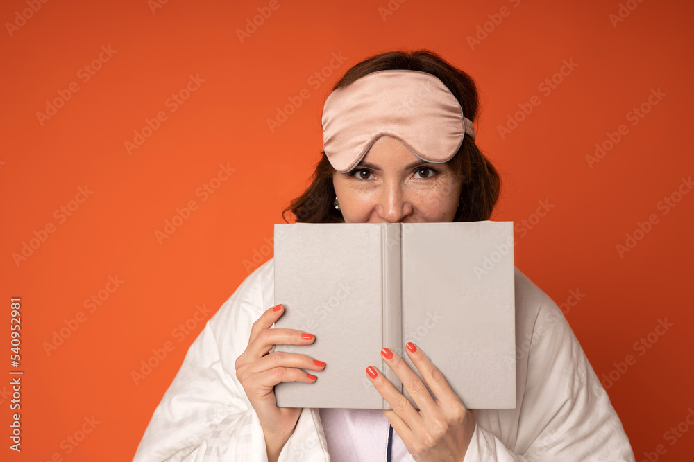 frightened adult woman in a blanket reading a book frightened adult woman in a blanket reading a book