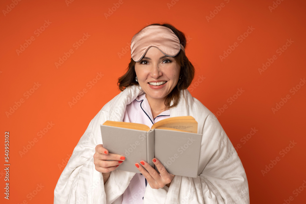 portrait of a cute adult woman with a book in a blanket portrait of a cute adult woman with a book in a blanket