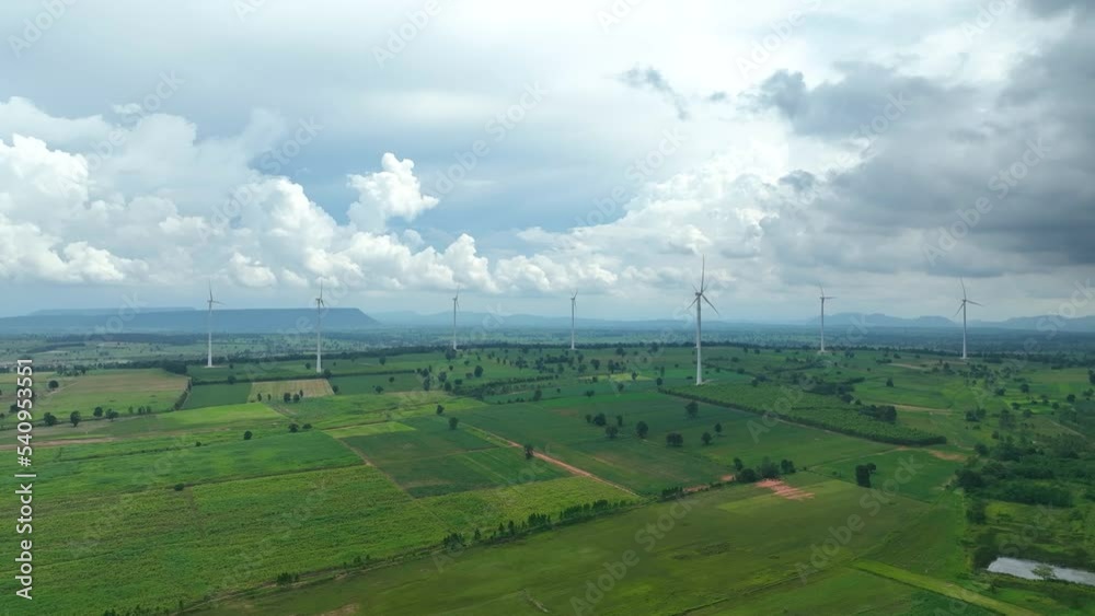 The blue sky background with clean energy at Solar panels with wind turbines generating electricity - Alternative renewable energy concept	