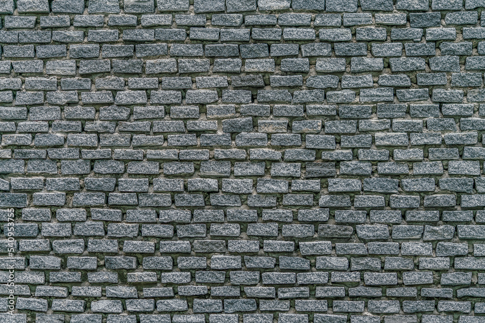 Fill the frame with grey brick wall background, weathered condition, and sunlight in the morning. Fill the frame with grey brick wall background, weathered condition, and sunlight in the morning.