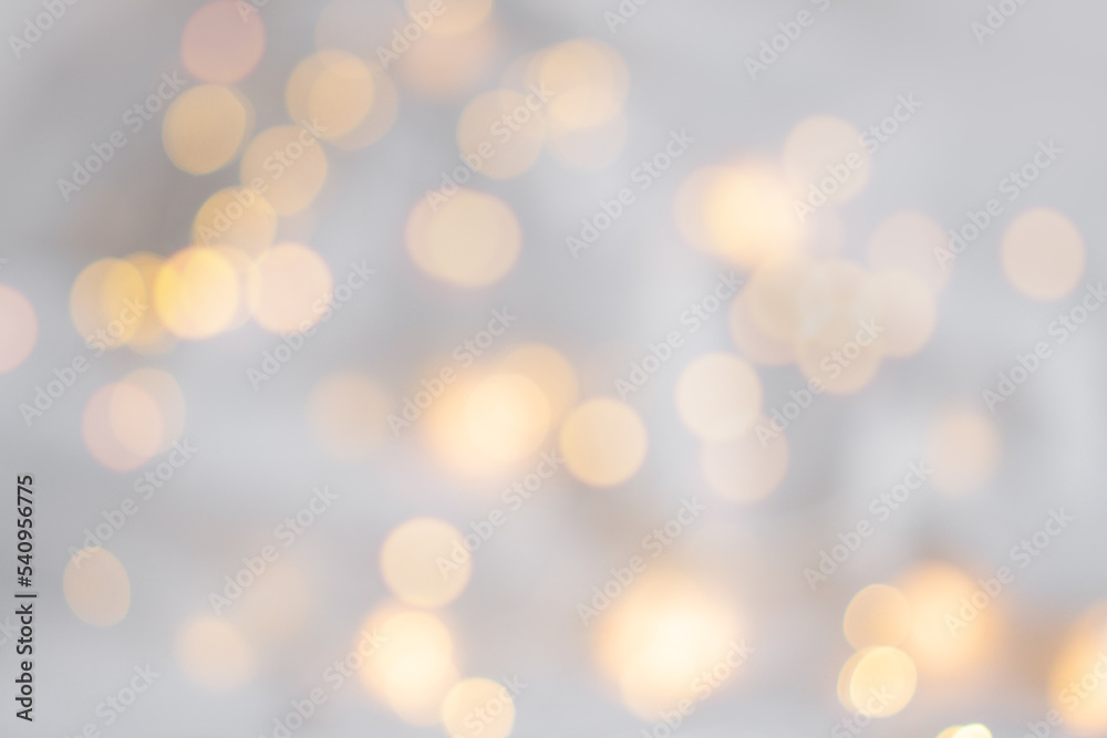 Xmas bokeh. Festive soft background with yellow bokeh of the garland. Christmas theme. The backdrop for web design, greeting, or invitation card. Happy holidays celebration