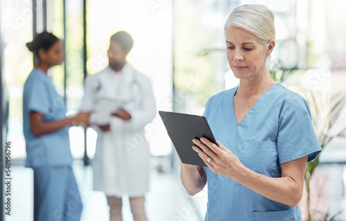 Nurse, tablet and hospital, health and woman check patient information, technology with digital medical data. Clinic, nursing and online medicine report, mature person and healthcare professional.