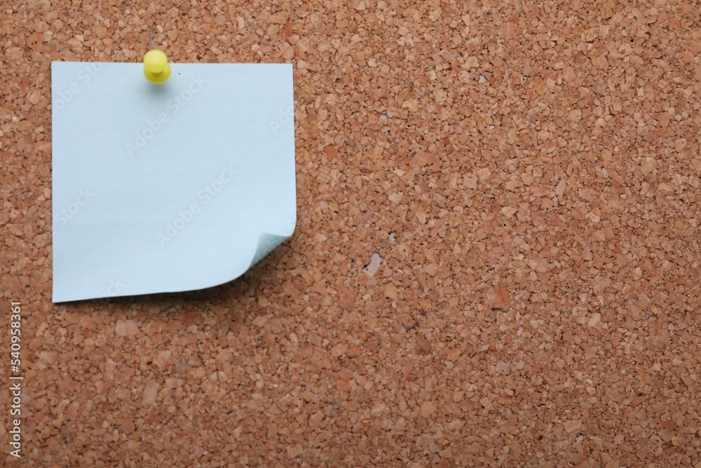 Blank paper note pinned to cork background, closeup. Space for text Blank paper note pinned to cork background, closeup. Space for text